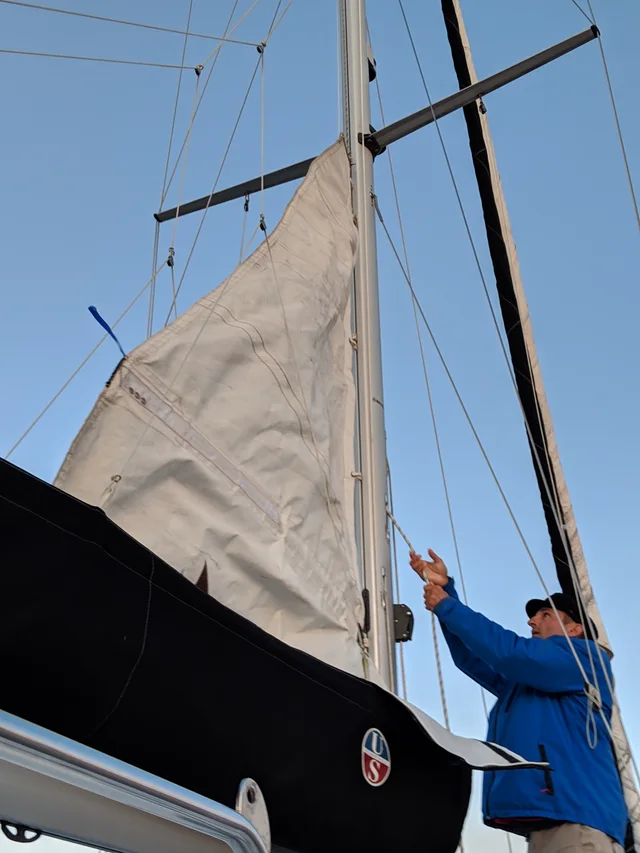 Working on the sail on deck