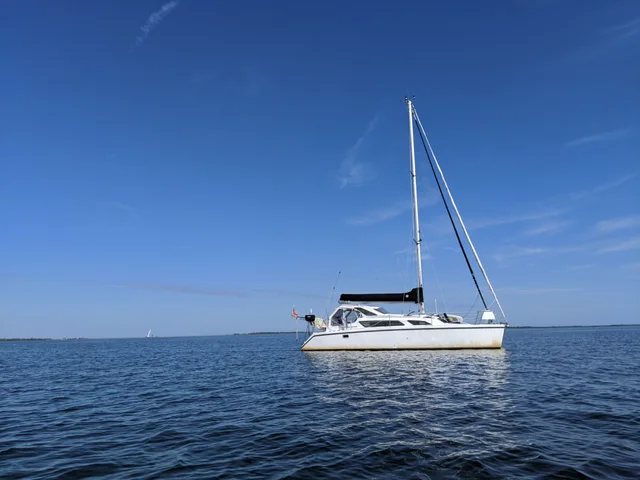 Mavis at anchor beneath a blue sky