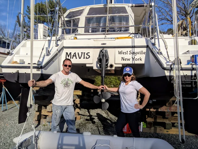 The crew beside Mavis in the boatyard