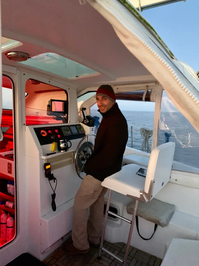 At the helm in the enclosed cockpit